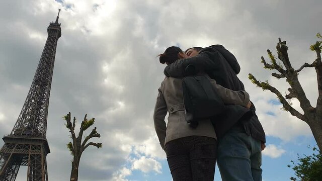 Couple in Paris kissing near Eiffel Tower