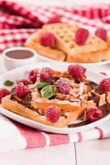 Waffles with raspberries and chocolate cream.