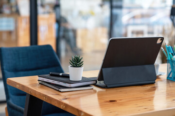 Back view of tablet placed on desk in office.