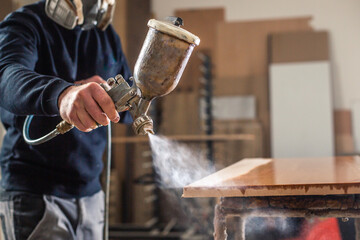 Process of varnishing or spraying wood by automatical spray in the professional joinery shop,...