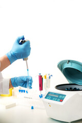 woman researcher using pipette to transfer resuspension of cells line from tube