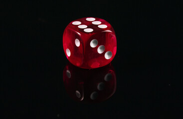 Red dice on a black background. Game addiction. Luck