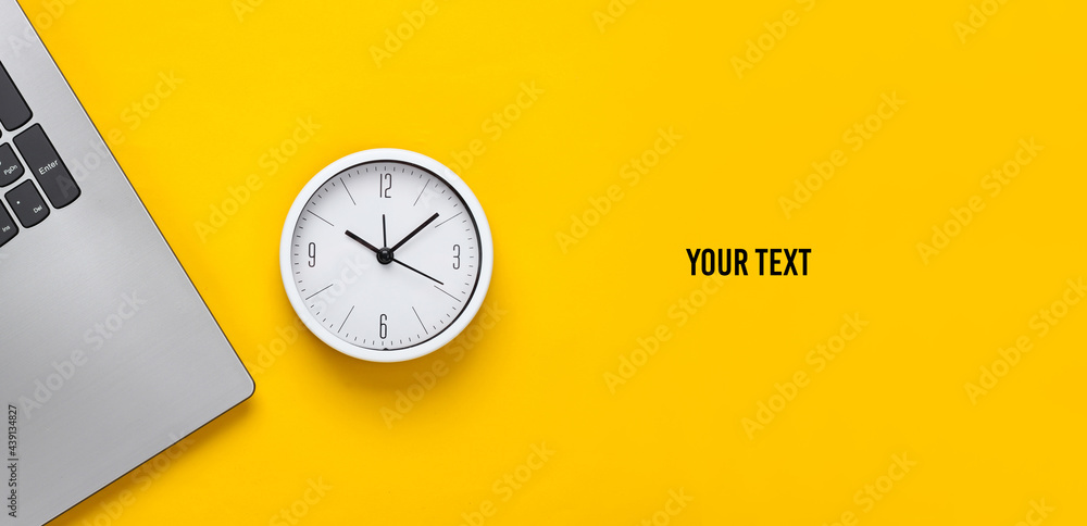 Poster laptop and alarm clock on yellow background. time running away. the concept of urgent deadlines at w