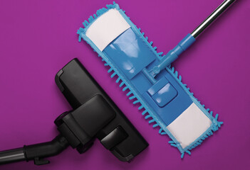Plastic mop and vacuum cleaner head on purple background. Disinfection and cleaning in the house....