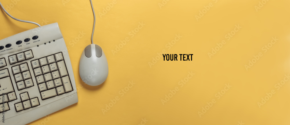 Leinwandbilder old-fashioned retro keyboard and pc mouse on yellow background. retro computer. top view. copy space