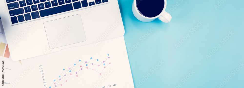 Poster laptop computer and documents report statistic financial with graph and chart and coffee on desk, fi