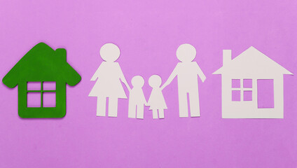 Paper family with houses on pink background