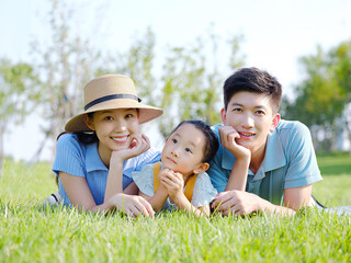 Happy family of three on the grass