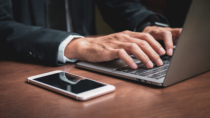 Businessman's hands with laptop while working in office, Businessman using laptop in office, Notebook on wooden table, Business concept