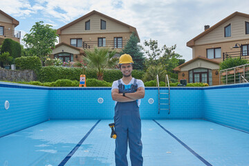 Repairman is repairing pool with equipment. Pool maintenance style.