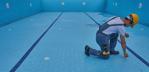 Repairman is repairing pool with equipment. Pool maintenance style. - obrazy, fototapety, plakaty