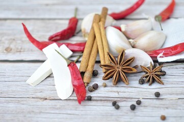 Herb spices such as Anise or octagonal sandalwood, cinnamon, black pepper, garlic, chili,on wooden background