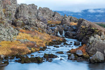 Naklejka na ściany i meble Long exposure photo of Drekkingarhylur (The drowning pool) in Thingvellir national park Iceland