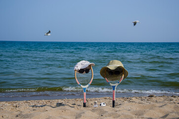 Badminton rackets in the sand of the beach