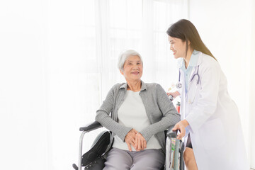 Obraz premium close up old asian patient sitting on wheelchair, old female talk about disease symptoms and treatment plan, happy hospital, rehabilitation activity, elderly healthcare promotion