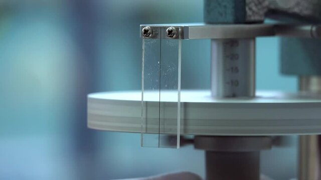 dial gauge calibration in scientific measurement lab. scientist adjusts the dial gauge. close up