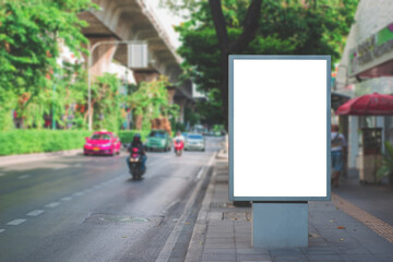 big blank billboard white LED screen vertical outstanding in the city side the road traffic for display advertisement text template promotion new brand at outdoor with green tree vintage color tone.