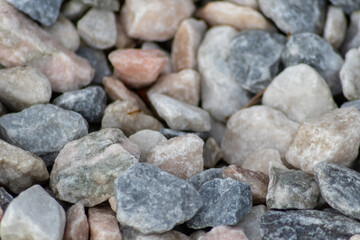 Raw rocks and minerals as natural stones background with crushed and rough material at a rough coast or rocky beach show nuggets and sandstones in harmonic pastel colors as natural mineral background