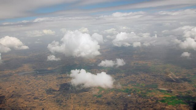 Aerial view from the plane of the Omo Valley in Ethiopia. mountains with mountain ranges, valleys and rivers in a landscape city. Textured clouds hanging over the mountain ranges.