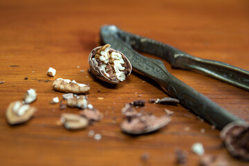 Vintage Nut Cracker with pecan nuts on a wood table