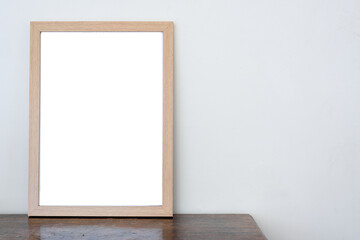 empty picture frame on wall and an old wooden table