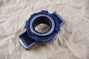 Car spare parts. Release bearing of a car on a background of craft paper.