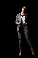 young beautiful girl in a business suit posing standing