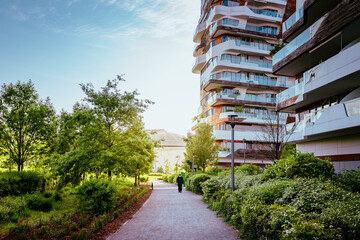 Naklejka premium Elderly walking under the modern apartments of CityLife, a district of Milan