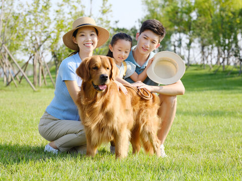 Happy family of three and pet dog in outdoor photo