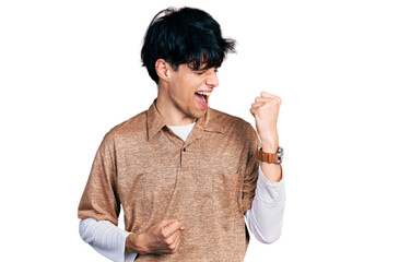 Handsome hipster young man wearing 90s retro style celebrating surprised and amazed for success...