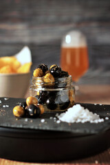 jar of black and green olives, lined with aromatic herbs appetizers, snacks and pickles