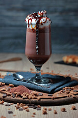 delicious and appetizing cup of cappuccino with whipped cream and caramel sauce and chocolate topping