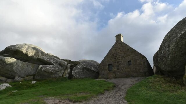 Meneham on the North Brittany coastline, France. Customs house built between a rocky outcrop overlooking the sea.