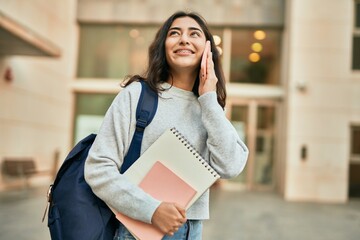 Young middle east student girl smiling happy talking on the smartphone at the city.