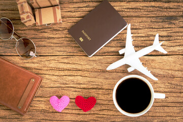 Coffee and airplane models and hearts with love and passport and luggage, Planning a holiday trip for couples.