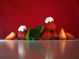 Strawberry with mint on red background