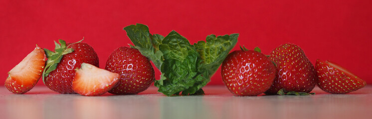 Strawberry with mint on red background