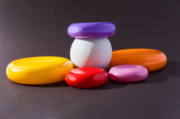 Set of colorful plastic rings on black backround