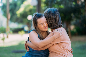 World Down Syndrome Day theme the young girl with Down syndrome with her mother’s in the park....
