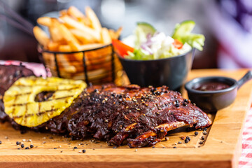 Ribs with salad and french fries in american restaurant