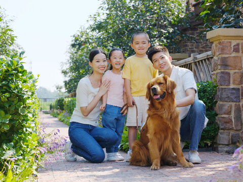 Happy family of four and pet dog in outdoor photo