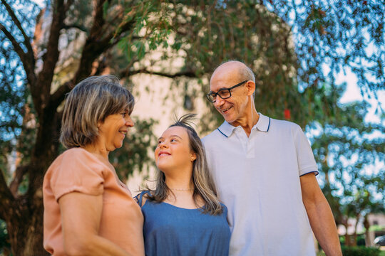 Latina Family Happy Outdoors With Daughter With Down Syndrome