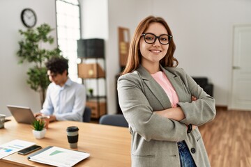 Business manager smiling happy with arms crossed gesture. Employee working at the office.