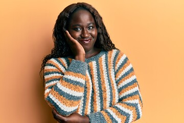 African young woman wearing wool winter sweater thinking looking tired and bored with depression problems with crossed arms.