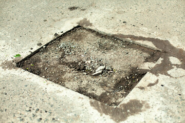 Road repair. Removing holes in the road. A cut piece of asphalt.