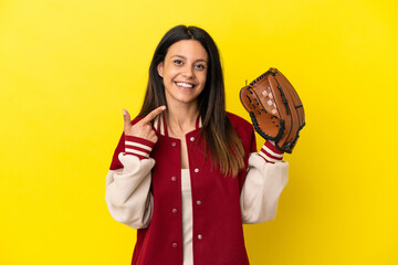 Young caucasian woman playing baseball isolated on yellow background giving a thumbs up gesture