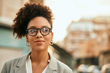 Young african american businesswoman smiling happy standing at the city.