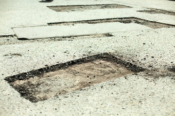 Road repair. Removing holes in the road. A cut piece of asphalt.