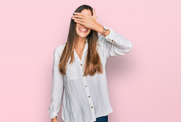 Young beautiful woman wearing casual clothes smiling and laughing with hand on face covering eyes for surprise. blind concept.