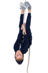 Active boy swing upside down on the rope